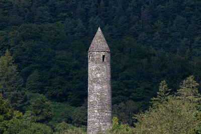 View of round tower and trees in forest