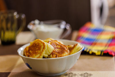 Homemade russian pancakes on ceramic bowl on dinner table