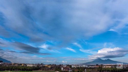 View of cityscape against cloudy sky