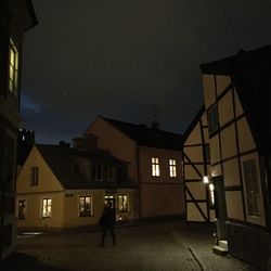 Illuminated buildings against sky at night