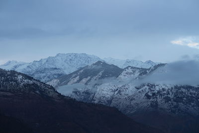 Scenic view of snowcapped mountains against sky