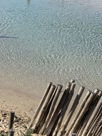 High angle view of wooden posts on beach