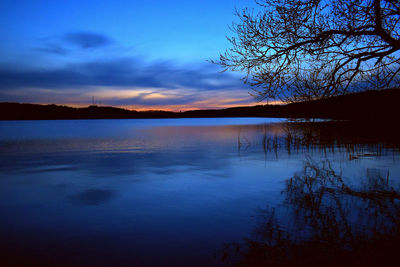 Scenic view of lake against sky at sunset