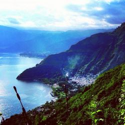 Scenic view of mountains against cloudy sky