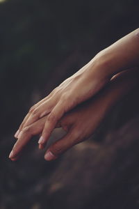 Close-up of hand touching finger