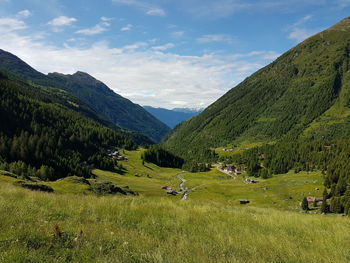 Scenic view of field and mountains against sky