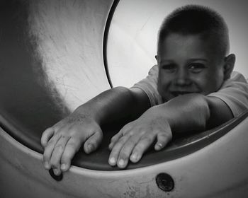 Portrait of boy enjoying in slide