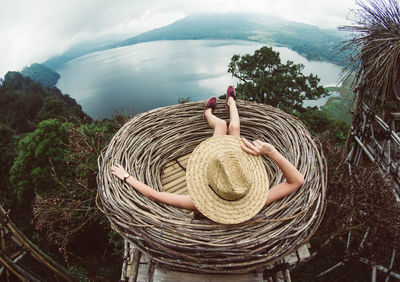 Rear view of woman wearing hat against trees