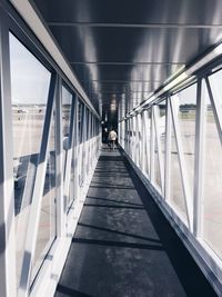 Rear view of people walking on corridor
