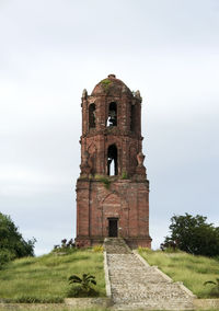 Old church on field against sky