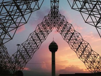 Low angle view of tower against cloudy sky