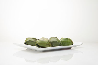 Close-up of sweet food on table against white background