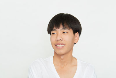 Portrait of smiling man against white background