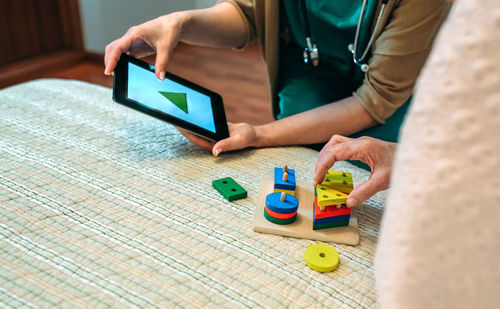 Nurse and senior patient using digital tablet in hospital