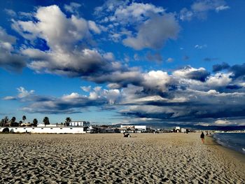 Scenic view of beach against blue sky