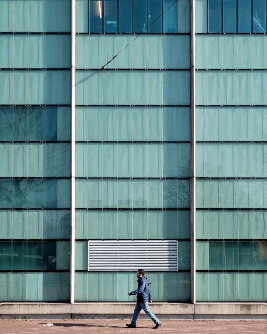 architecture, building exterior, built structure, full length, lifestyles, leisure activity, casual clothing, city, walking, standing, men, rear view, building, person, side view, modern, city life, day