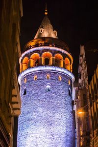 Low angle view of illuminated cathedral against sky at night