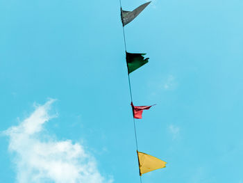 Low angle view of flags flag against sky