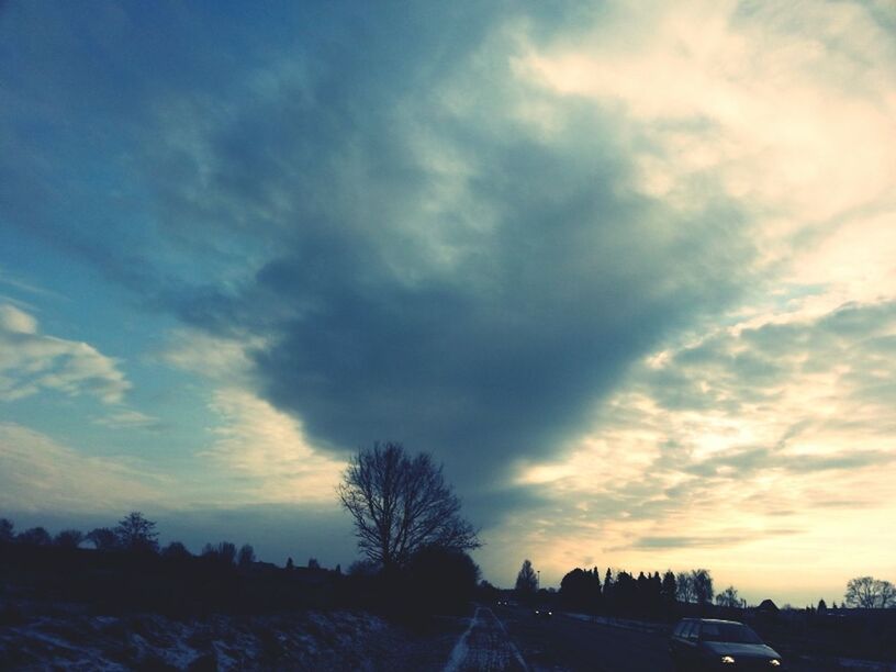 transportation, sky, car, land vehicle, road, cloud - sky, tree, mode of transport, sunset, silhouette, the way forward, street, cloud, cloudy, nature, bare tree, outdoors, scenics, beauty in nature, no people