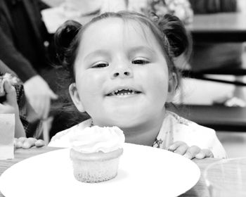 Portrait of cute girl with ice cream on table