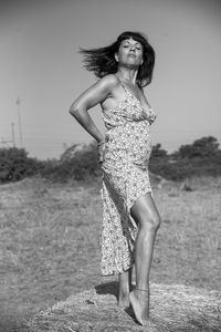 Portrait of woman standing on field