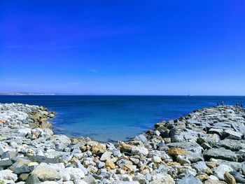 Scenic view of sea against clear blue sky