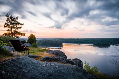 Scenic view of calm lake against cloudy sky