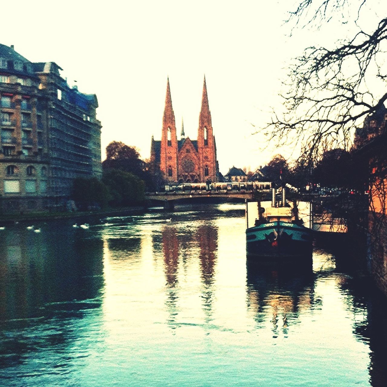 architecture, built structure, water, building exterior, waterfront, reflection, clear sky, river, lake, tree, canal, religion, outdoors, travel destinations, sky, place of worship, rippled, famous place, no people, travel