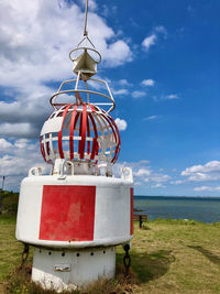 Metallic structure on beach against sky