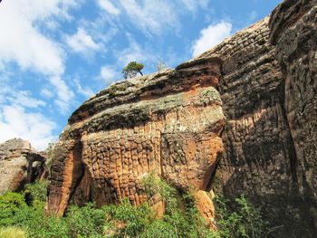 Low angle view of rock formations against sky