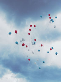 Low angle view of balloons against sky