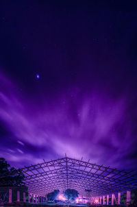 Low angle view of illuminated building against sky at night