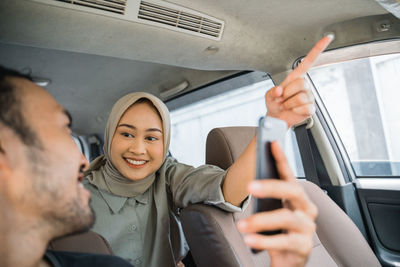 Portrait of senior man sitting in car