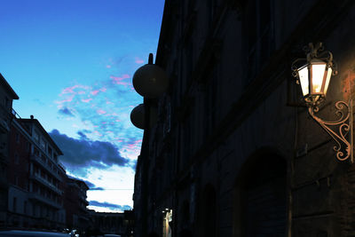Low angle view of illuminated buildings against sky
