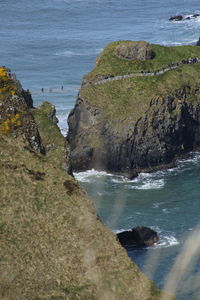 Scenic view of sea by cliff