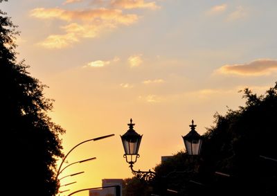 Low angle view of street light against sky at sunset