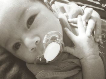 Close-up of baby hand on bed