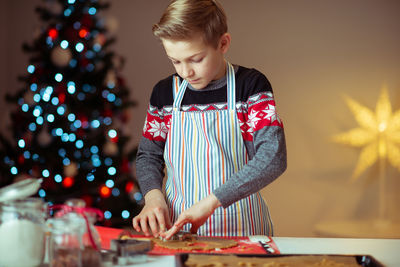 Boy playing with umbrella on table