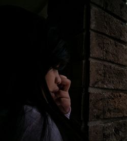 Close-up of girl standing by wall