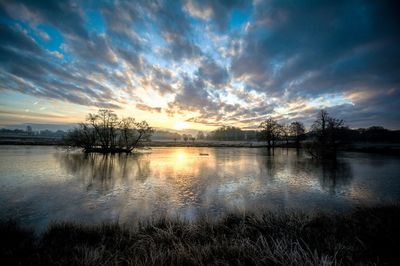 Scenic view of lake against sky during sunset