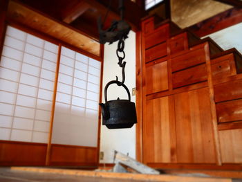 Close-up of electric lamp hanging on wall