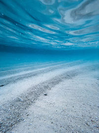 Scenic view of beach against blue sky