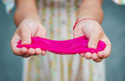 Cropped hand of woman holding heart shape