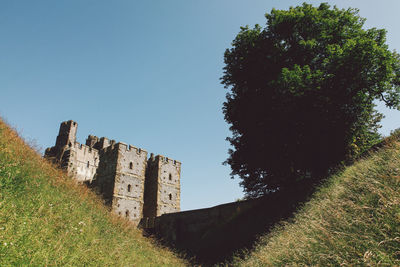 Low angle view of built structure against clear blue sky