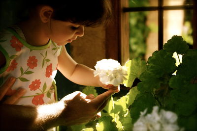 Close-up of woman holding flower