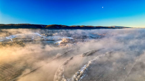 Scenic view of snowcapped mountains against clear blue sky