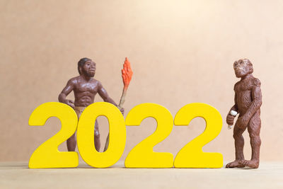 Close-up of statue against yellow background