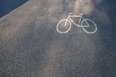 High angle view of bicycle lane sign on road