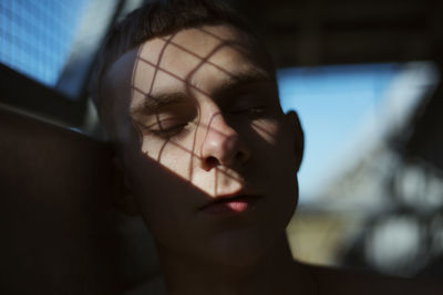 Close-up portrait of young man looking away