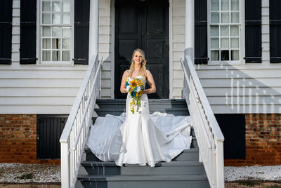 Woman standing against building